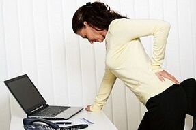 Eine Frau hat Rückenschmerzen in der Lendengegend